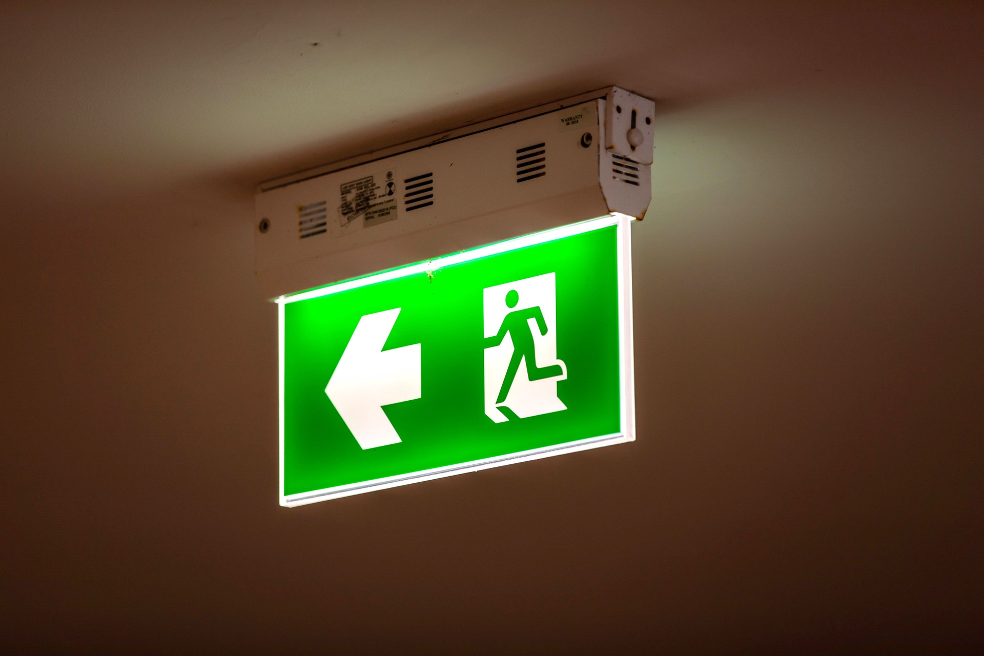 Fire exit sign along a building corridor, ensuring safety and guidance, perfect for interior, emergency, and safety themes.